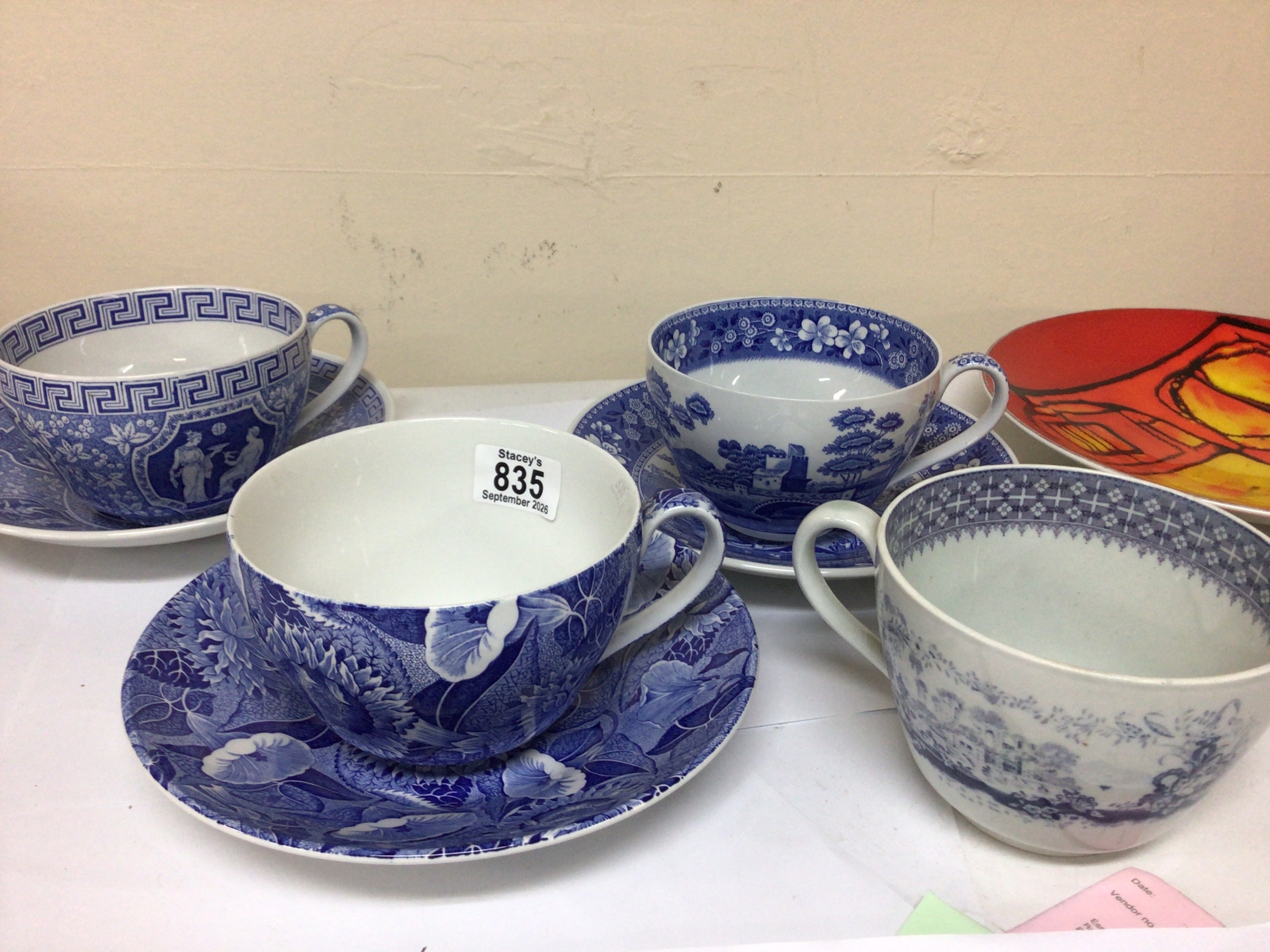  A collection of large blue and white tea cups modern Poole pottery and other ceramics.