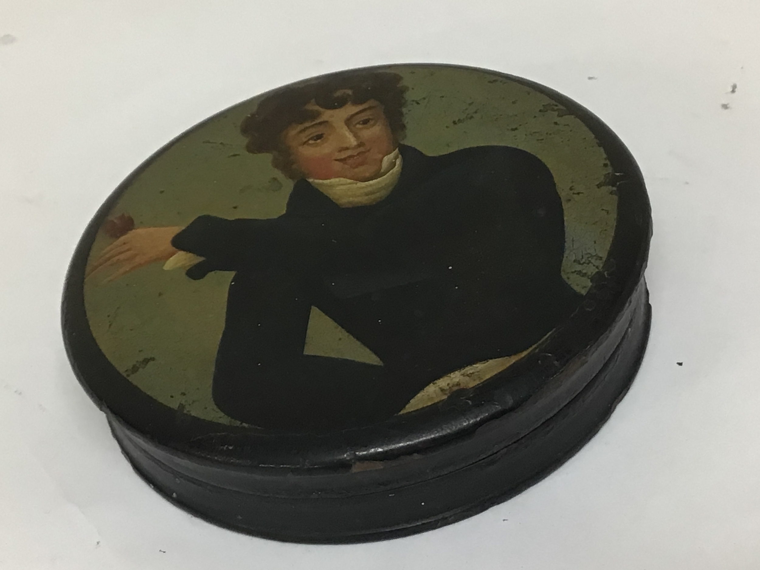 An Early Victorian snuff box hand painted with a Gentleman raising a glass.