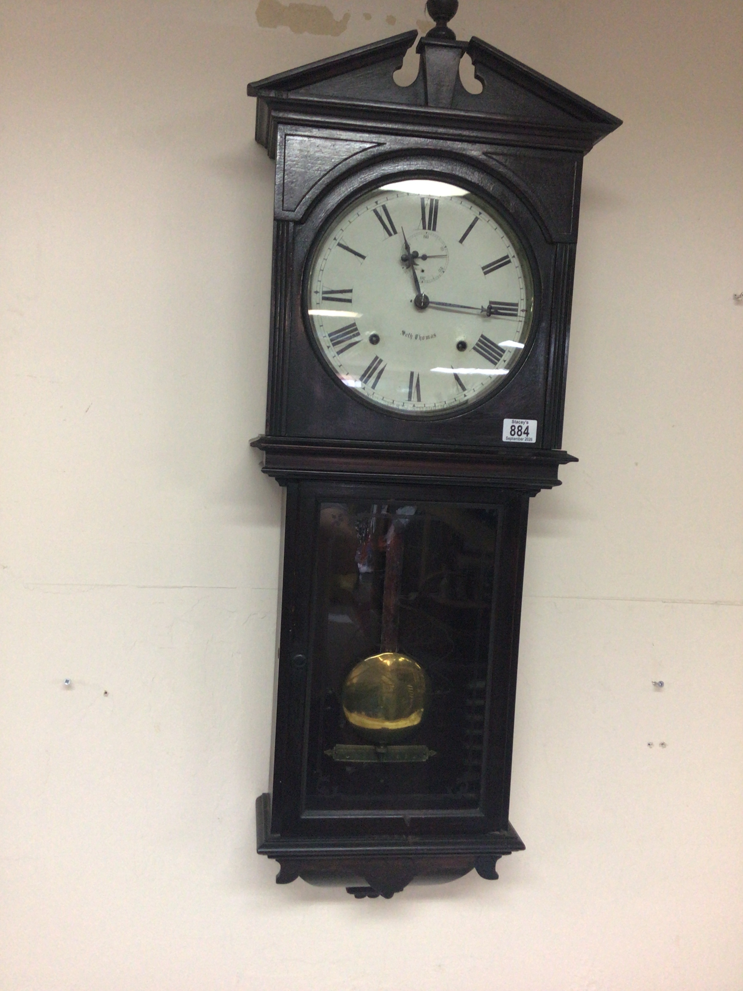  A Victorian American wall clock Seth Thomas with a visible pendulum. Length 102cm 