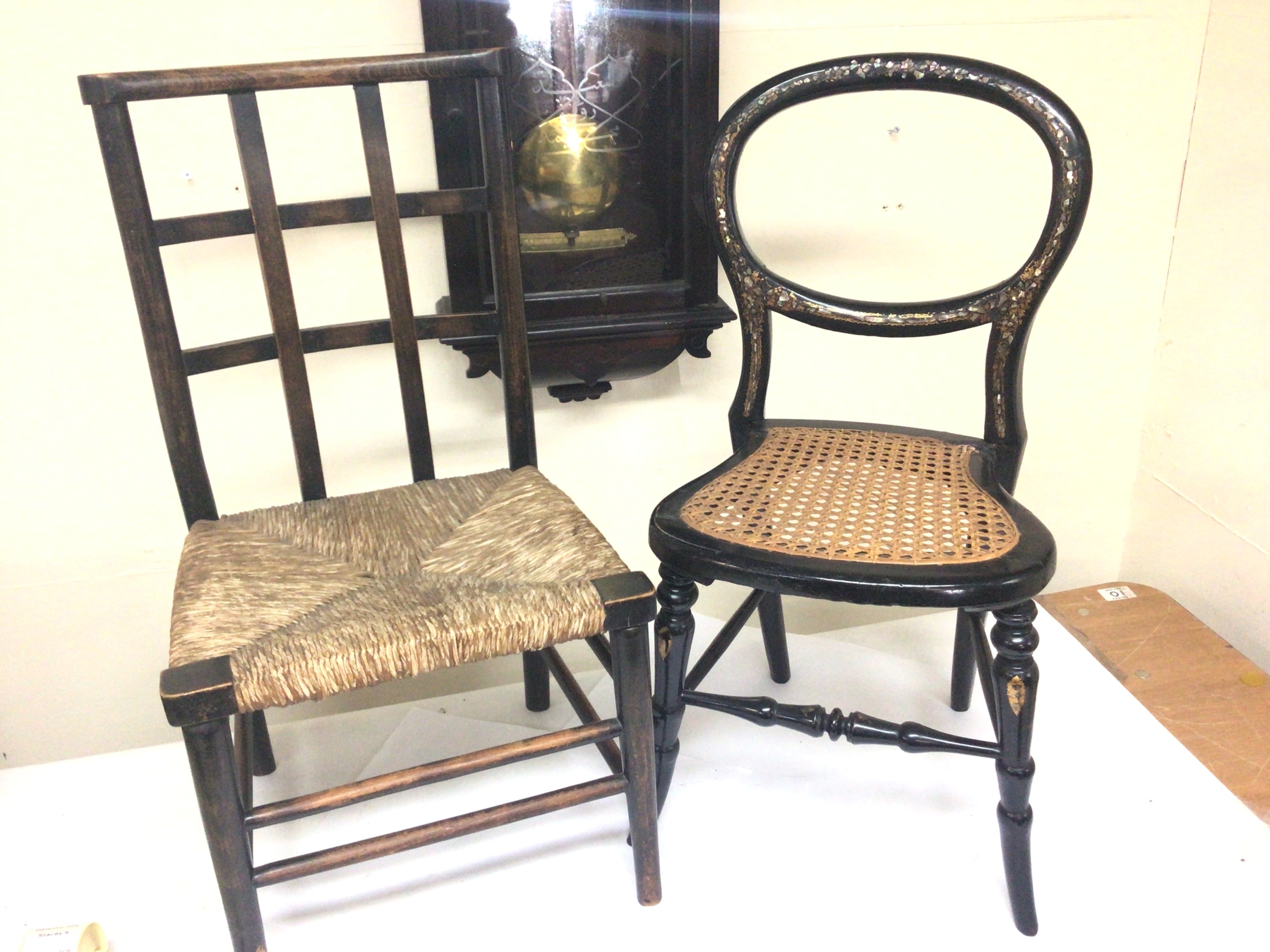  A Nice example of a Victorian mother of pearl inlaid papier-mâché child's chair and a Vernacular child's chair with a rush seat. (2)  