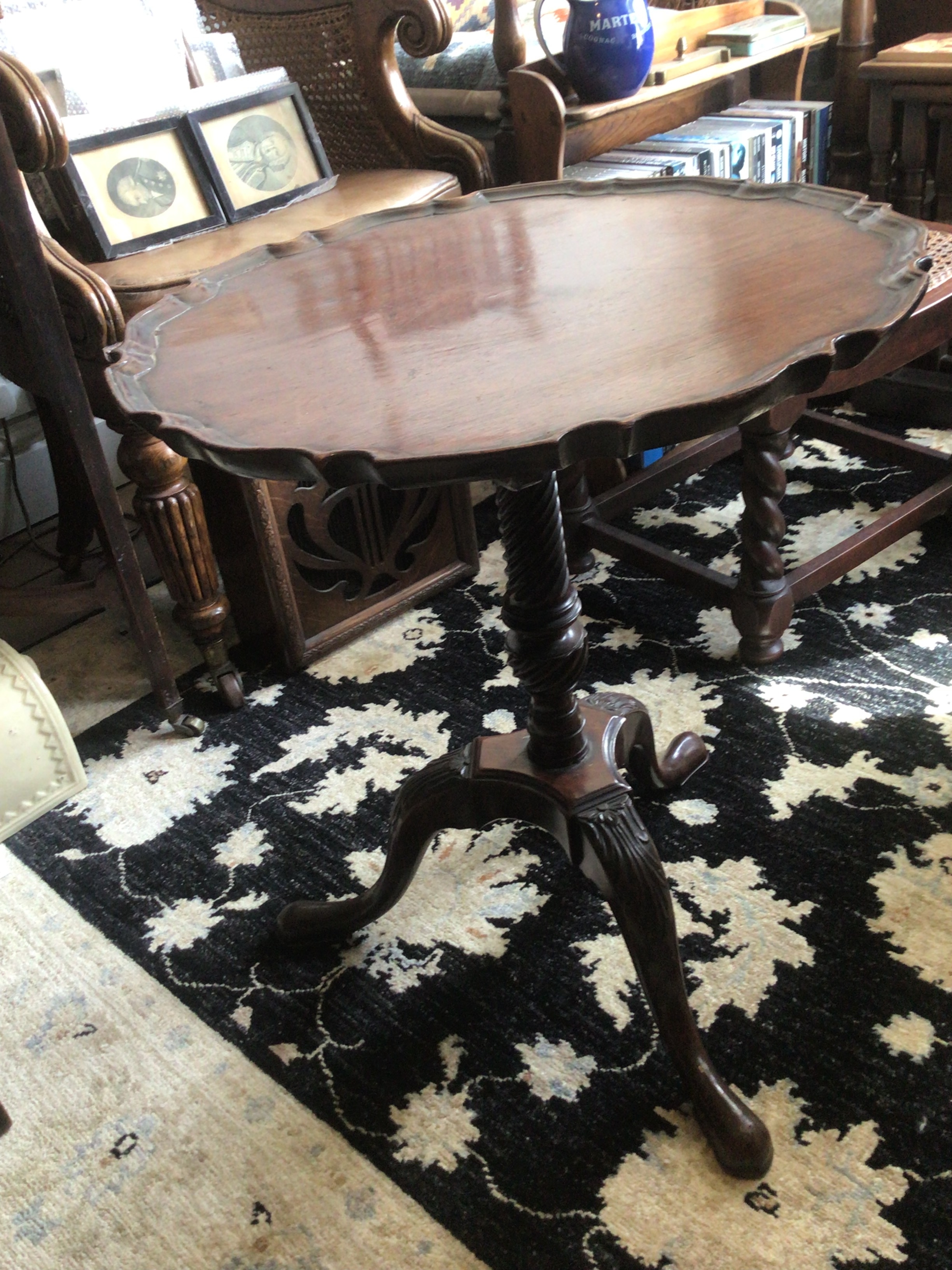  A late George III possible restored Mahogany occasional table with a shaped top and half fluted column and carved scroll legs.  