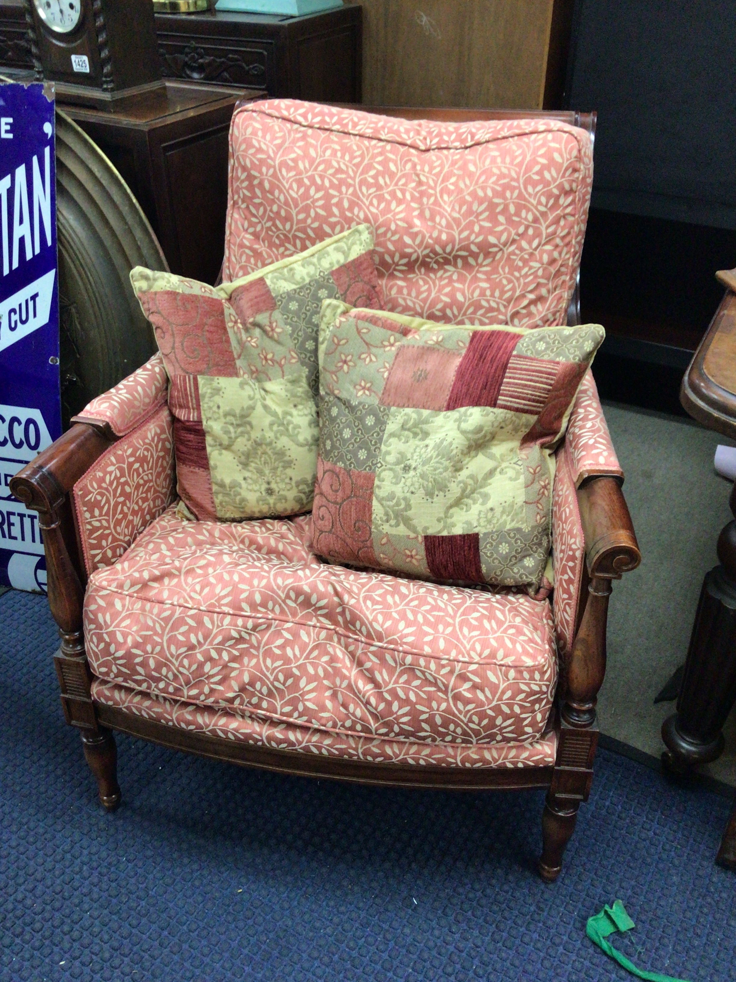 A Regency style arm chair with a patterned fabric and loose cushions good condition
