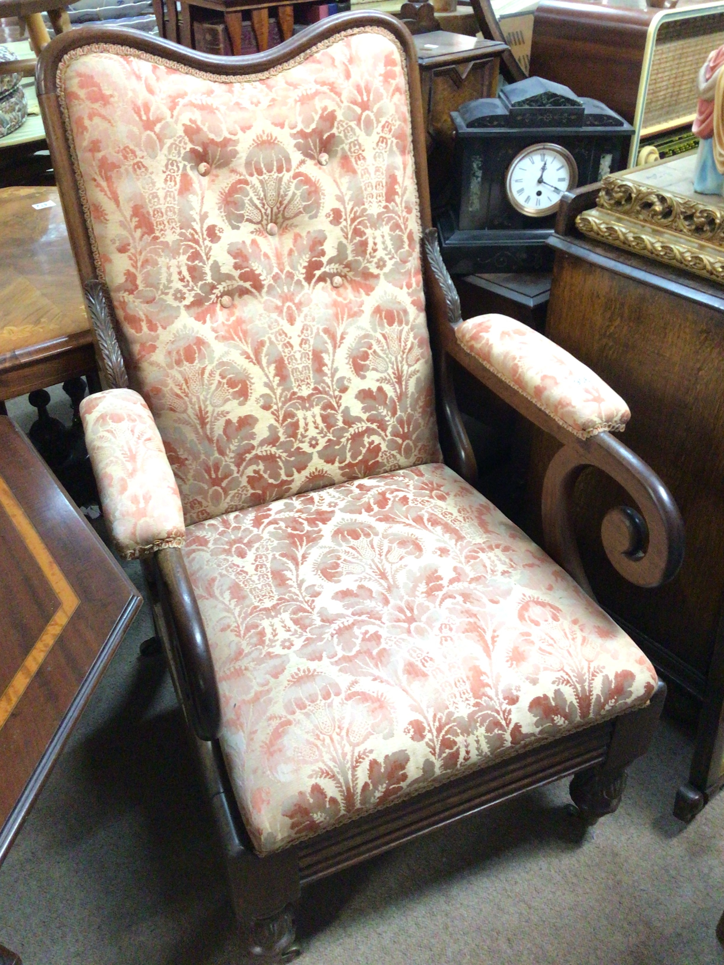  A William VI early reclining chair with stylised acanthus leaves scroll arms and floral upholstery. 