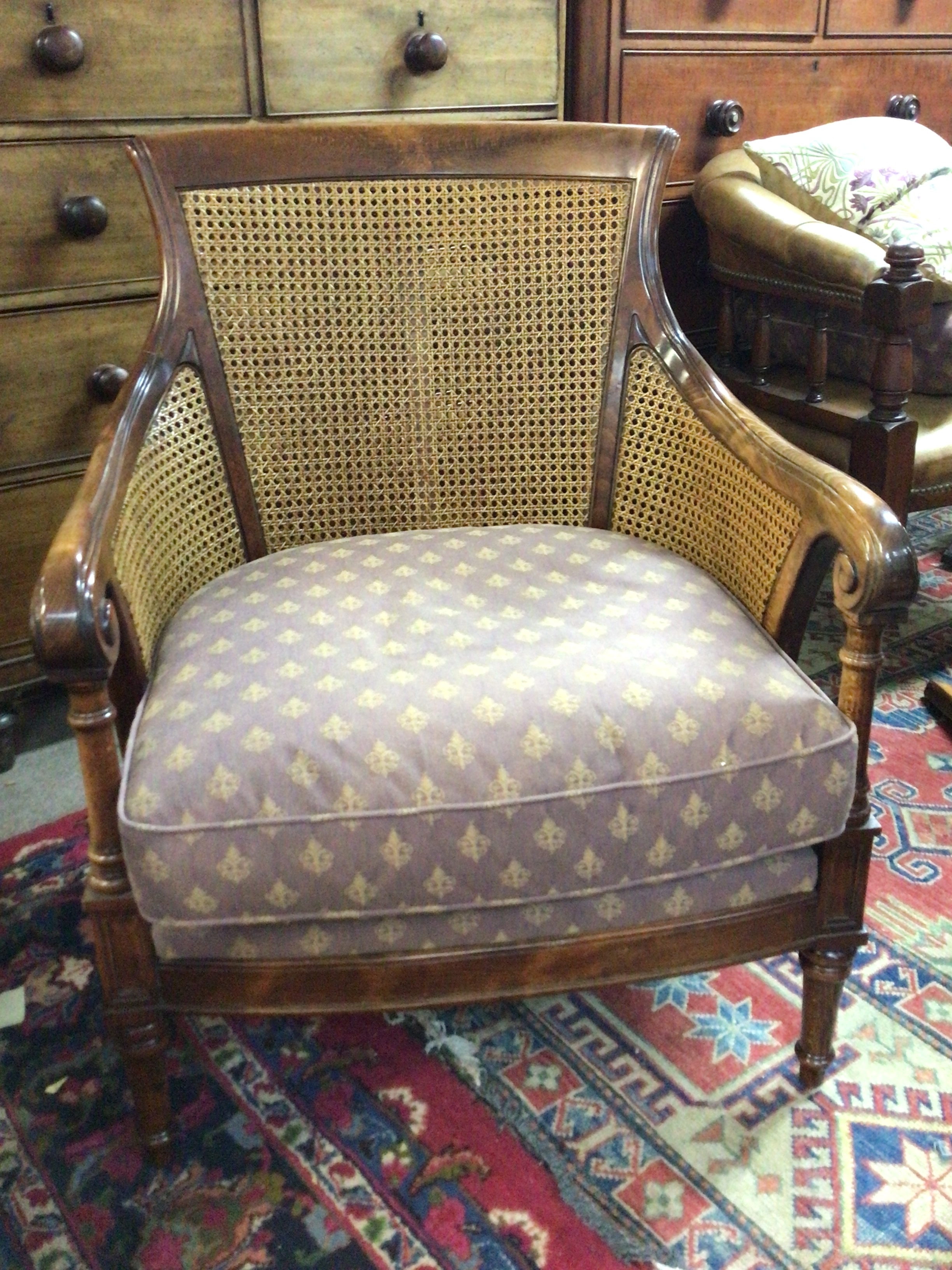  A quality beechwood double cane arm chair wide seat with a drop in cushion. 