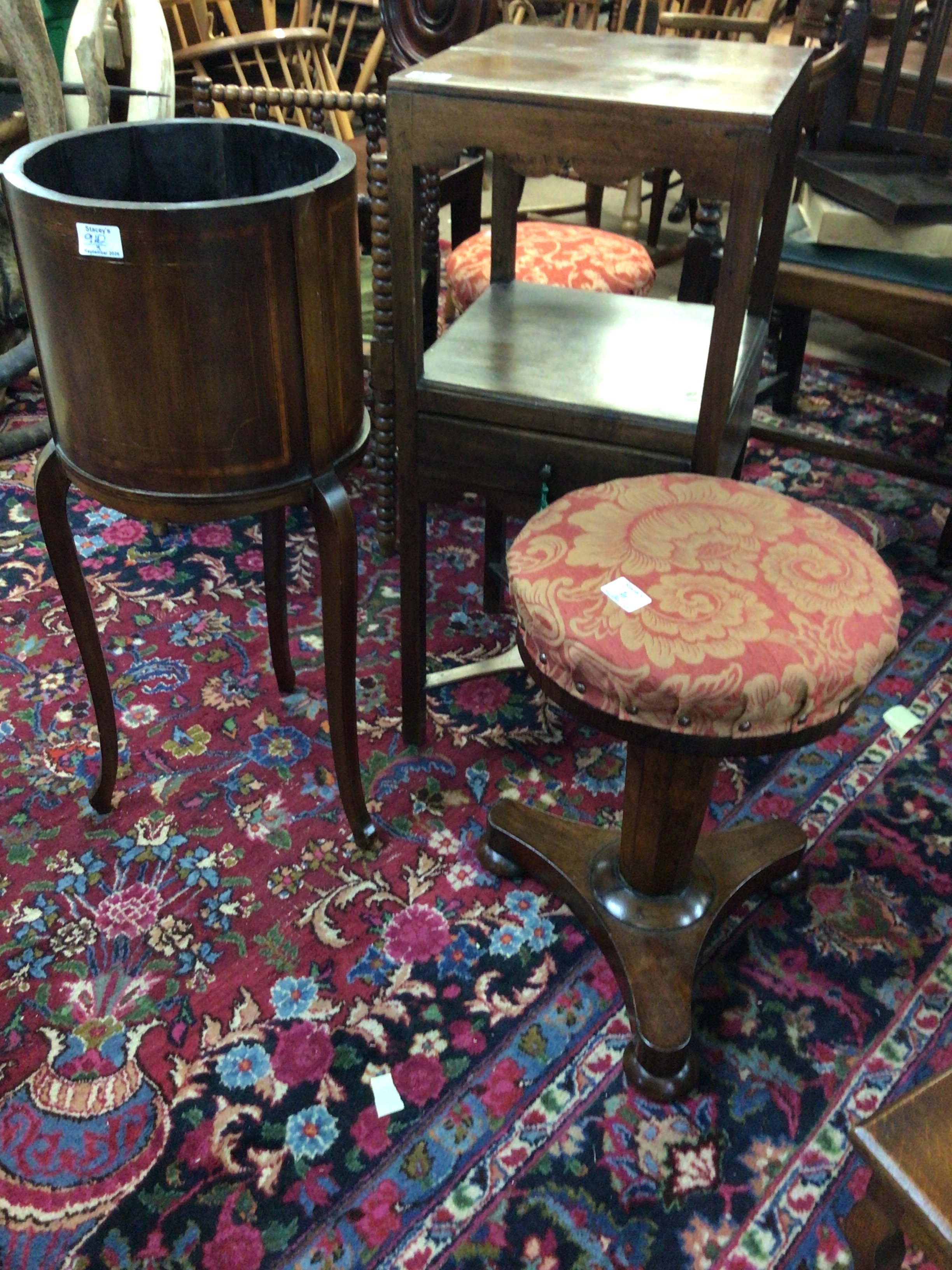A George III mahogany wash stand an Edwardian mahogany jardiniere holder a Rosewood music stool (3) 
