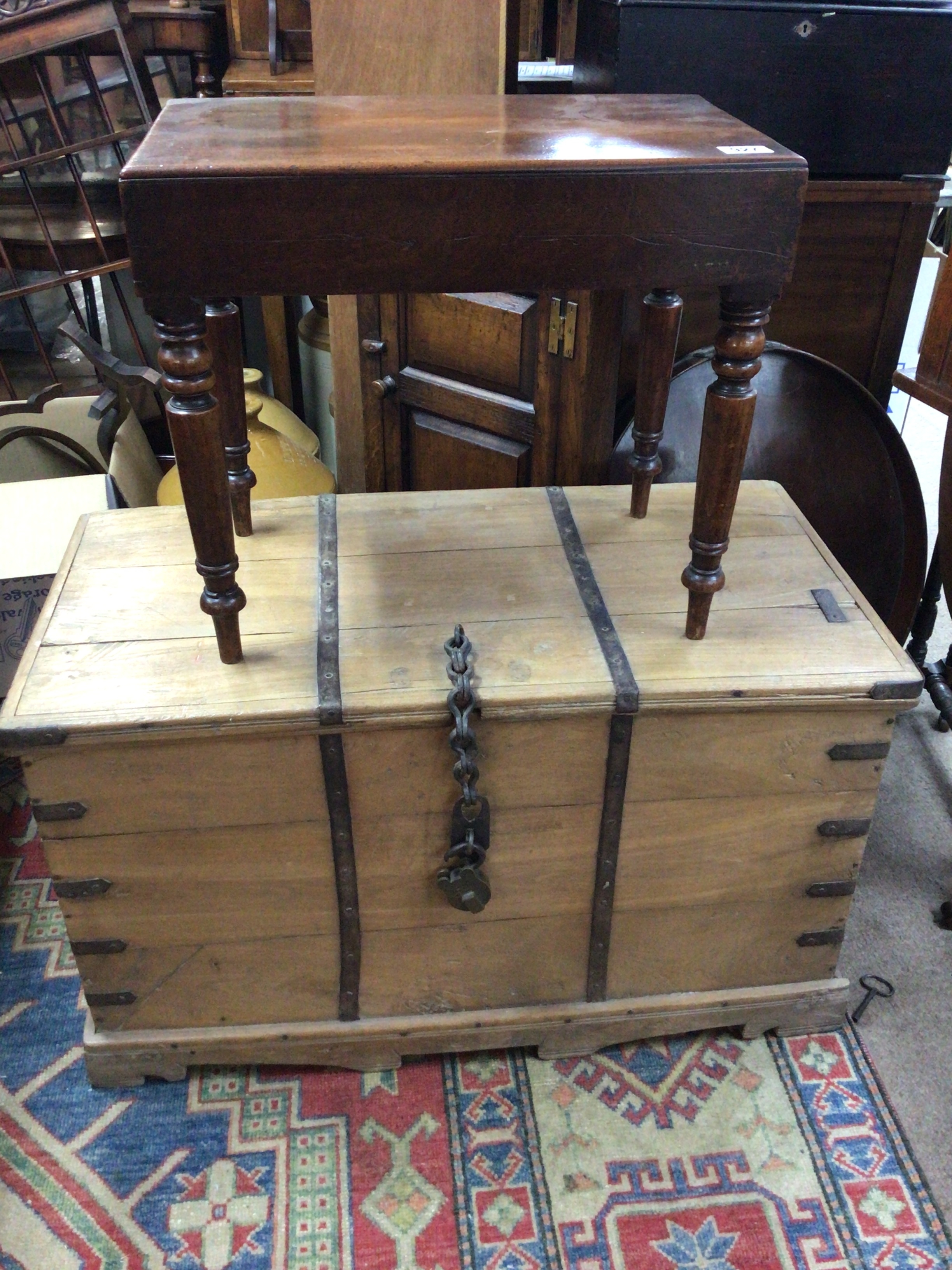  A Victorian metal bound pine trunk of rectangular shape and a Victorian mahogany small tin bath with lift off rectangular cover (2) 