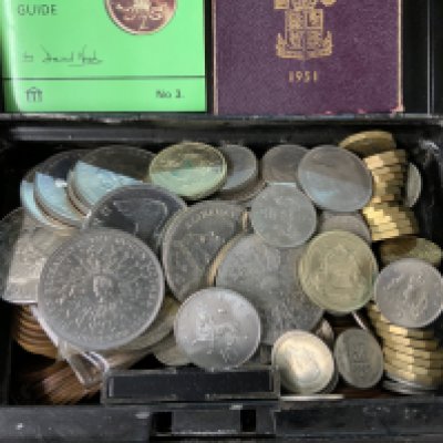A tin of British coinage.