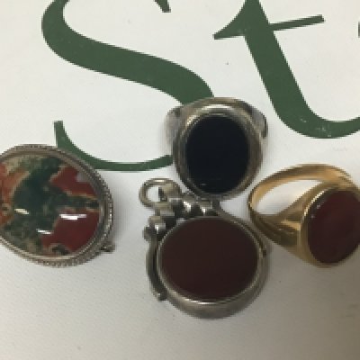 A Gents ring set with an intaglio unmarked weight 4.8g approximately a silver ring moss agate polished brooch and a swivel fob (4)