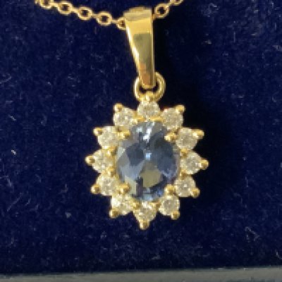 18ct yellow gold oval sapphire and RBC diamond cluster necklace, boxed. Sapphire 0.75ct. Diamonds 0.28ct. Postage category A.