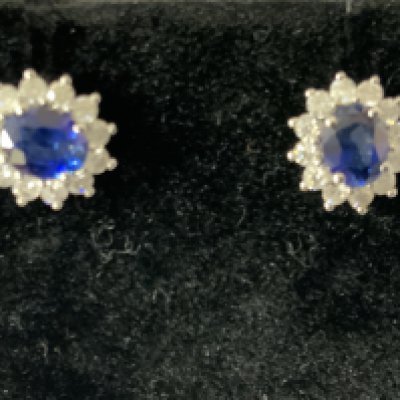 Pair of 9ct white gold oval sapphire and RBC diamond cluster studs, boxed. Sapphires 0.93ct. Diamonds 0.31ct. Postage category A.