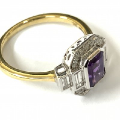 9ct yellow and white gold art deco style dress ring set with a step cut amethyst and baguette cut and RBC diamonds. Amethyst 0.78ct. Diamonds 0.52ct. Approx ring size N. Postage category A