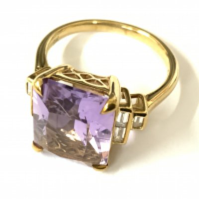 Stylish 9ct yellow gold ring set with a large rectangular amethyst flanked by baguette diamonds. Amethyst 5.68ct. Diamonds 0.23ct. Approx ring size N. Postage category A