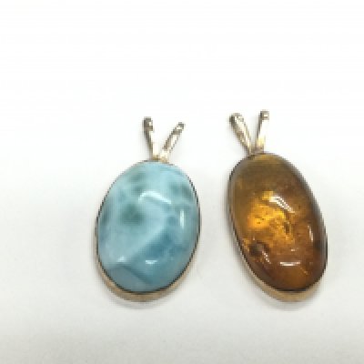 WITHDRAWN - Two 14ct gold pendants comprising one set with amber and one other. Shipping category A.