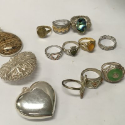 A collection of 10 silver dress rings and three pendants .