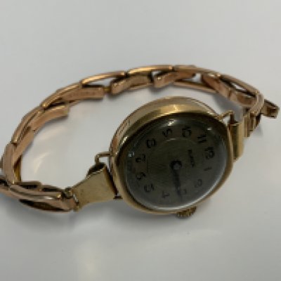 A 9ct gold Buren wristwatch with expanding unmarked strap. (A)