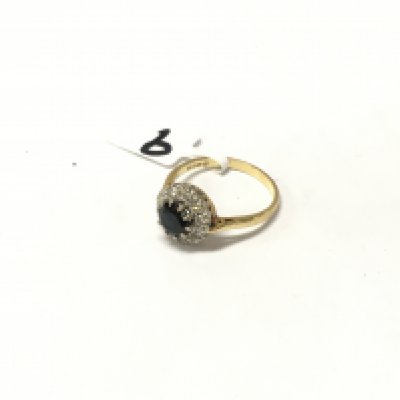 An 18ct gold diamond and sapphire ring. Size P 1/2, Approx weight 3.84 grams.