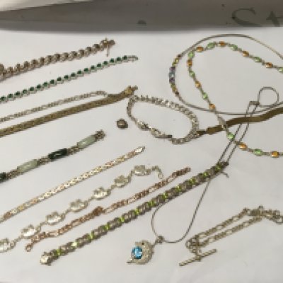 A collection of silver bracelets and necklaces.