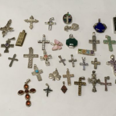 A collection of silver cross pendants .