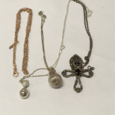 Three silver chains with attached pendants