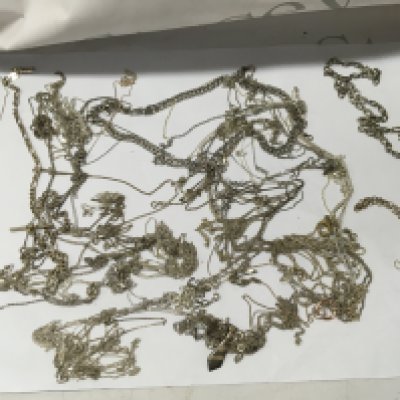 A collection of various silver necklaces .
