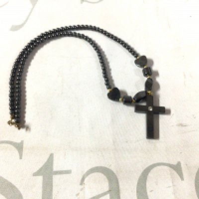 A hematite cross pendant and necklace with a 9ct gold clasp.