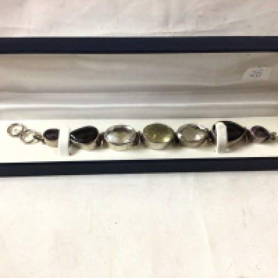 A Silver stone set bracelet, set with quartz stones, amethyst and citrines.