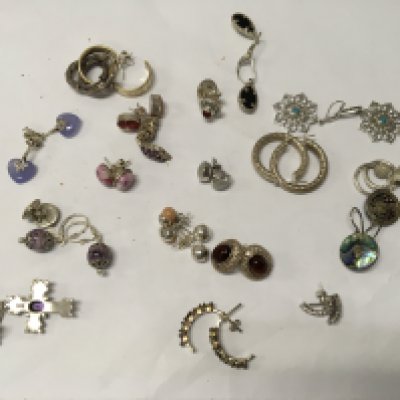 A collection of silver earrings.