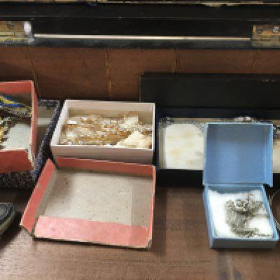 A mahogany box containing costume jewellery various.