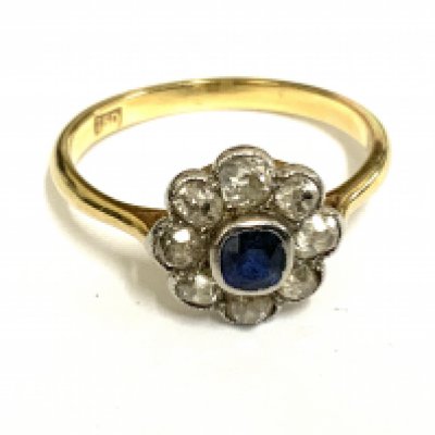 An 18ct gold sapphire and diamond daisy cluster ring, Size Q. (A)