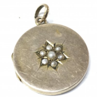 An unmarked gold locket set with pearls . 4.4g total weight. Postage category A