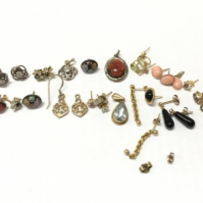 A collection of gold and silver earrings , postage category A
