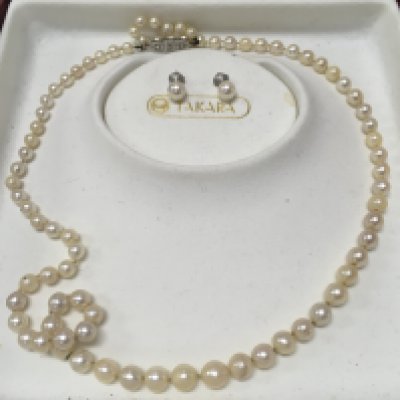 A Takara pearl necklace set with 18 carat diamond set clasp and matching earrings , postage category B
