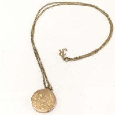 A 9ct gold locket and chain . 10g total weight. Postage category a