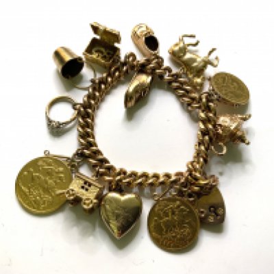 A heavy 9ct gold chain with attached charms, 1912 Full Sovereign, 1910 Half Sovereign, 1873 2.5 dollar piece. 75.6g