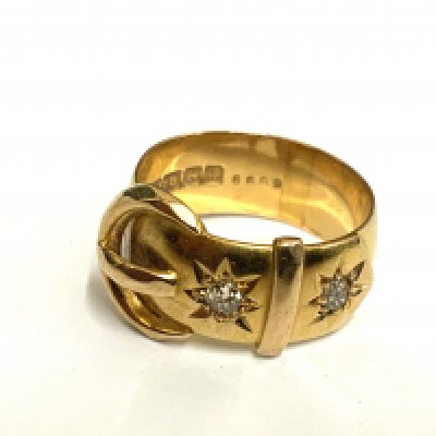 An 18ct yellow gold belt and buckle design ring inset with 2 old cut diamonds .c.1910, Size L. 6.7g.