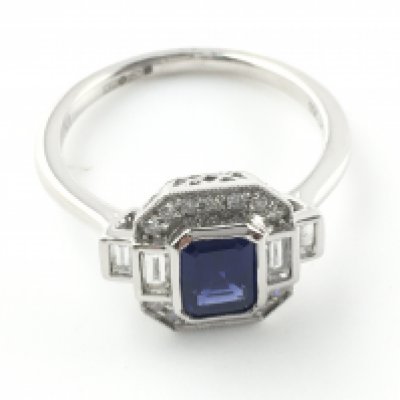 Platinum Art Deco style ring set with a step cut sapphire and round and baguette cut diamonds. Sapphire 1.15ct and diamonds 0.34ct. Size N 1/2. Postage A