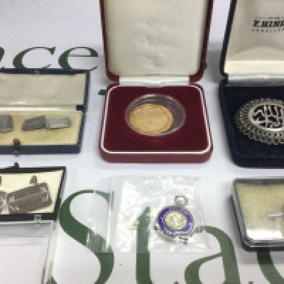 A small collection of silver items comprising a brooch, cufflinks etc.
