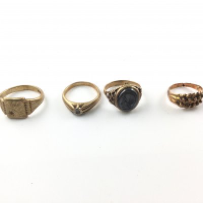 A collection of four gents 9ct gold rings. 18.95g total. Postage B