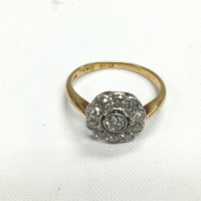 An 18ct gold and platinum diamond cluster ring, approx 3.6g and approx size O. Shipping category A.