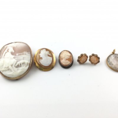 Three early cameo brooches including two 9ct gold examples and a 800 silver one. A pair of 9ct gold cameo earrings and an 18ct hair locket. Postage B