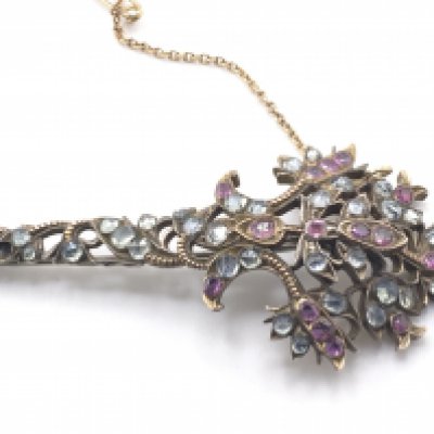A fine Edwardian brooch (conversion) inset with a spray of Pink rubies and Aquamarine rose cut stones, possibly originally a section from a tiara. (Missing one stone), inconclusive results for metal (gold/silver). 7.5cm x 3.5cm. Total weight 15.60g.