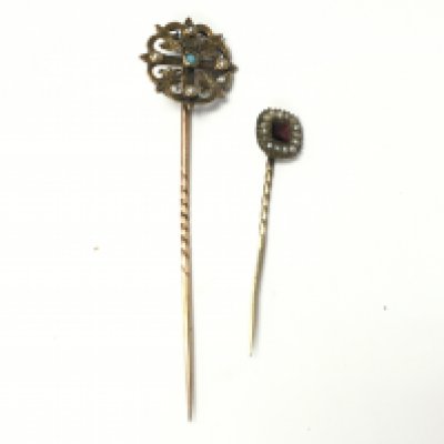Two stick pins in a fitted case set with seed pearls. Postage A. NO RESERVE