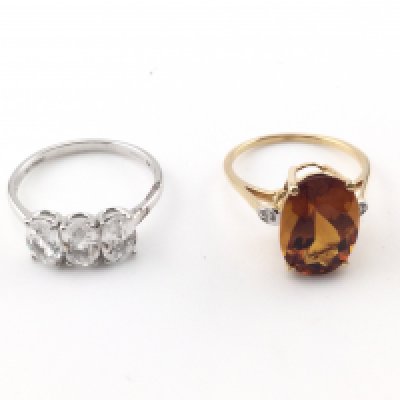 A 10k white gold three stone ring 2.8g and size R and a 14k gold cocktail ring size P and 3.40g Postage B