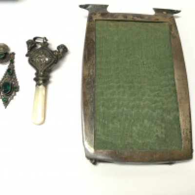 A silver picture frame and childs rattle and a pair of vintage dress earrings. Postage B. NO RESERVE