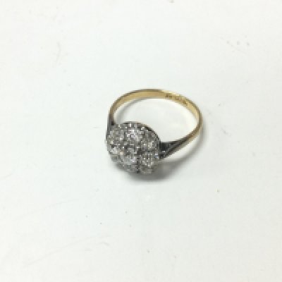 An 18ct gold and platinum diamond cluster ring set with old cut diamonds. Approx weight 3.24 grams, size P.
