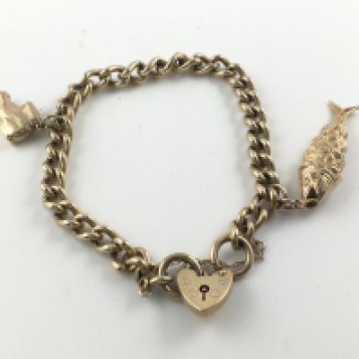 A 9ct gold charm bracelet with a heart padlock. 39g Postage B