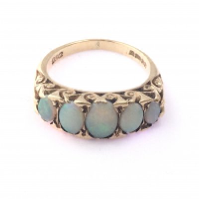 A 9ct gold ring set with 5 opals. Size N and 4.85g