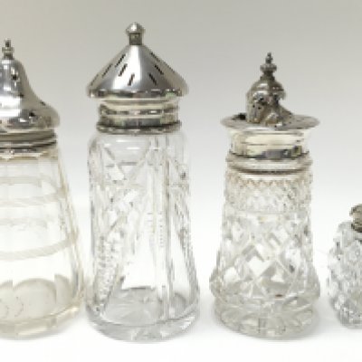Four cut glass sugar casters with silver hallmarked tops, this lot cannot be posted