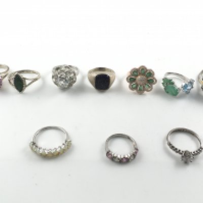 A collection of 10 silver rings set with assorted stones including opal. Postage B