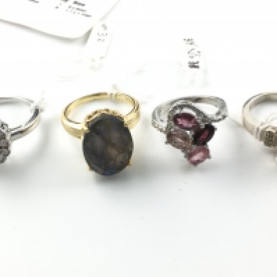 Four silver rings set with assorted gems including fire opal and yellow diamonds. Postage B